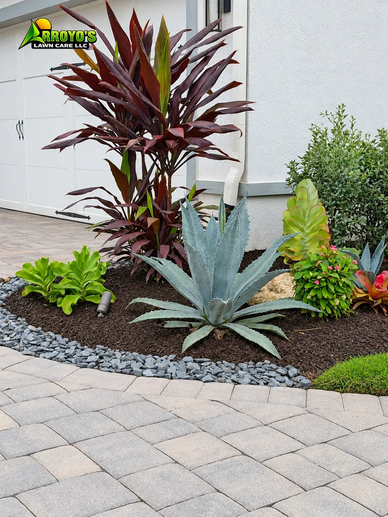Corner accent bed: red cordyline, agave, and a gray rock edge